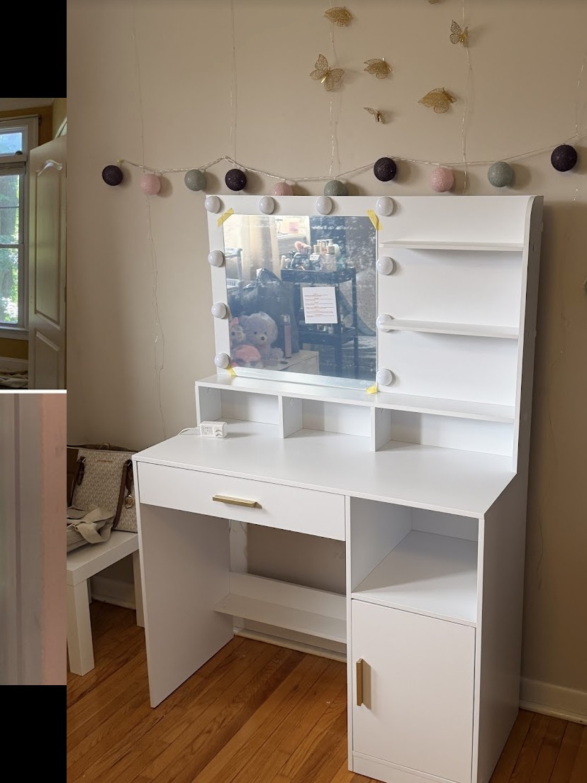 Assembled white vanity with mirror in residential bedroom